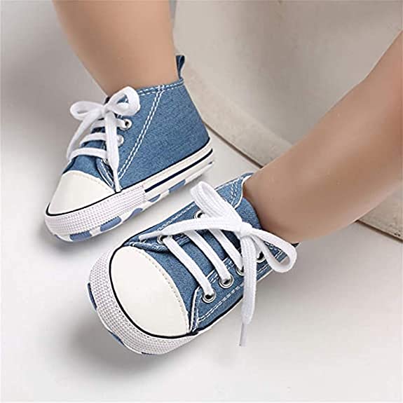 White slippers with a bow for a little girl. pair of baby shoes. Baby shoes  on a pink background. Children's denim shoes for girls Stock Photo - Alamy